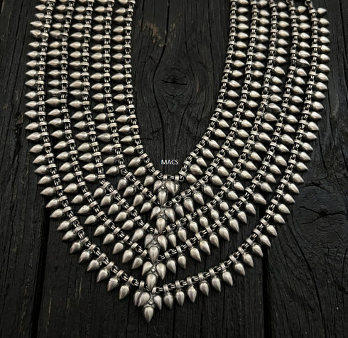 925 silver layered statement necklace with multiple curved rows of metallic spikes and teardrop charms