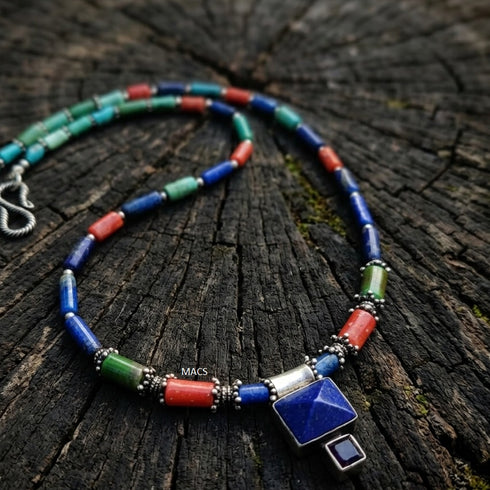 Colorful beaded lapis necklace with a square pendant on a wooden surface