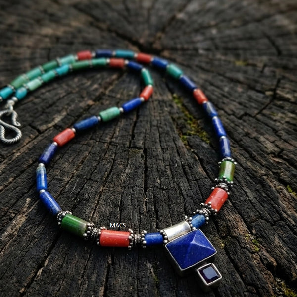 Colorful beaded lapis necklace with a square pendant on a wooden surface