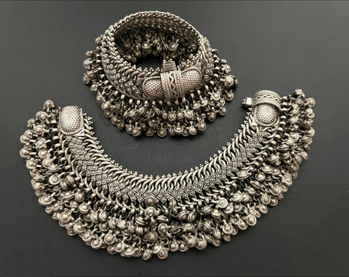 A pair of vintage pure silver anklets with floral patterns and multiple layers of ghungaroo design