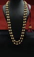 Gold dholki beaded necklace on a black mannequin