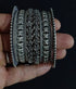 a stack of ornate 925 pure silver bangles with intricate floral and geometric embossed patterns